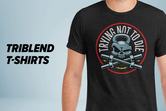 Black funny workout shirt with a Trying Not To Die graphic and 'TRIBLEND T-SHIRTS' text on a light blue-gray background