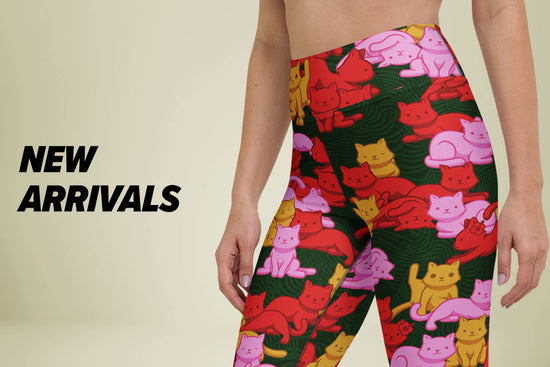 A model wearing high-waisted Tropical Camo Cats leggings shown against a beige background with 'NEW ARRIVALS' text on the left.