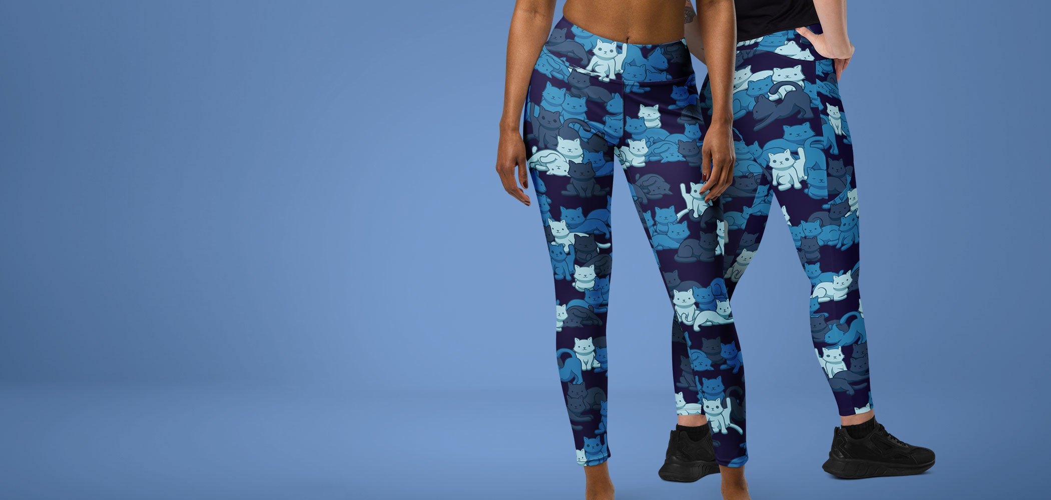 Models wearing the new Navy Camo Cats leggings against a blue gray background.
