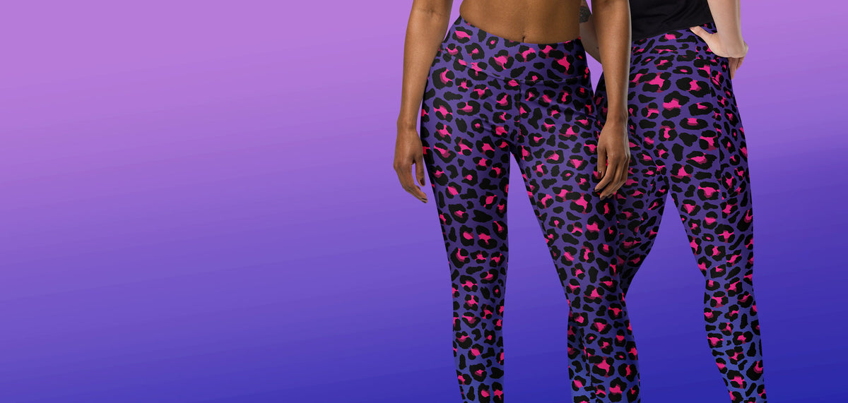 A pair of women's leggings with the new Cyberpunk Leopard Print pattern, black and pink leopard spots on a dark purple to blue base, modeled on two women against a purple blue gradient background.